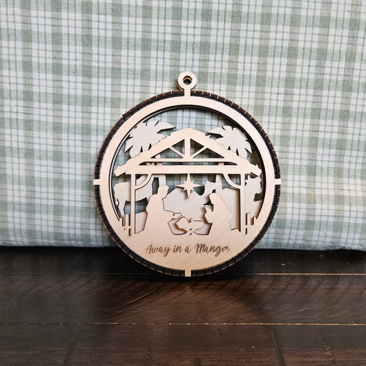 2-Layer wooden ornament with the words "Away in a Manger" under the nativity in the foreground and animals in the background.